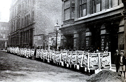 Some thirty-odd sandwichboard men ready to parade around Birmingham advertising, 'Clarke's Thunder Clouds Tobacco'