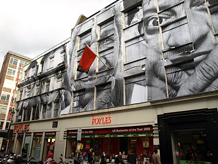 Artwork papered onto Foyles and surrounding buildings, Manette Street, central London