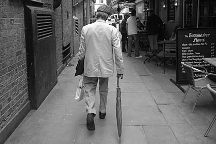 Flat cap and umbrella, Leicester Square, London, July 2007