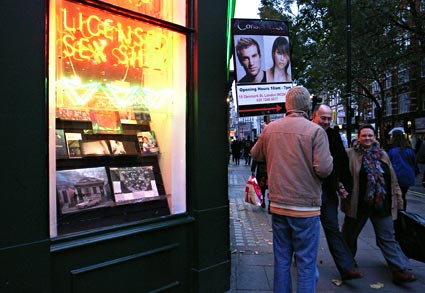Sex shop and human billboard, Charing Cross Road, Soho, London