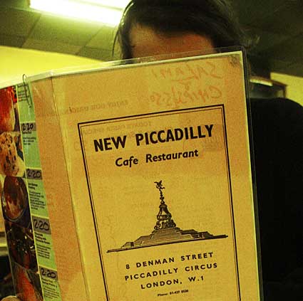 Reading the menu, New Piccadilly café, Denman Street, Piccadilly, London