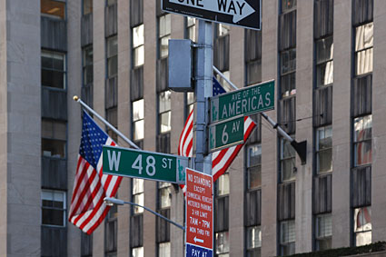 Street signs and flags, 48th Street and 6th Avenue, Manhattan, New York, NYC, November 2006