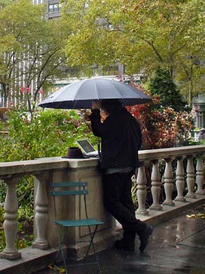 Umbrella and laptop, Bryant Park, Manhattan, New York
