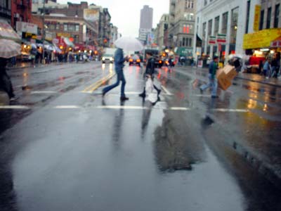 Crossing Canal Street in the rain, Chinatown, Manhattan, New York