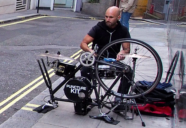 Puncture Kit busker plays on a drum kit made from a bicycle