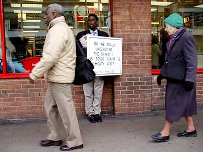 Man with religious billboard, Brixton Road, Brixton, Lambeth, London SW9, Nov 2003