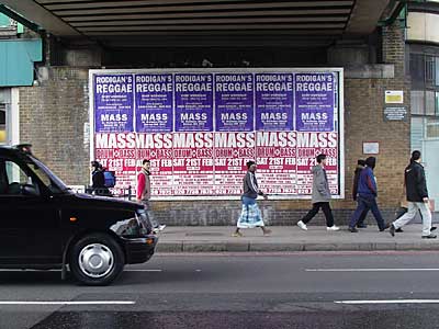 Posters and pedestrians, Brixton Road, Lambeth, London SE22