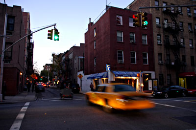 A cab rolls over Carmine St, Manhattan, New York, New York City, NYC, USA